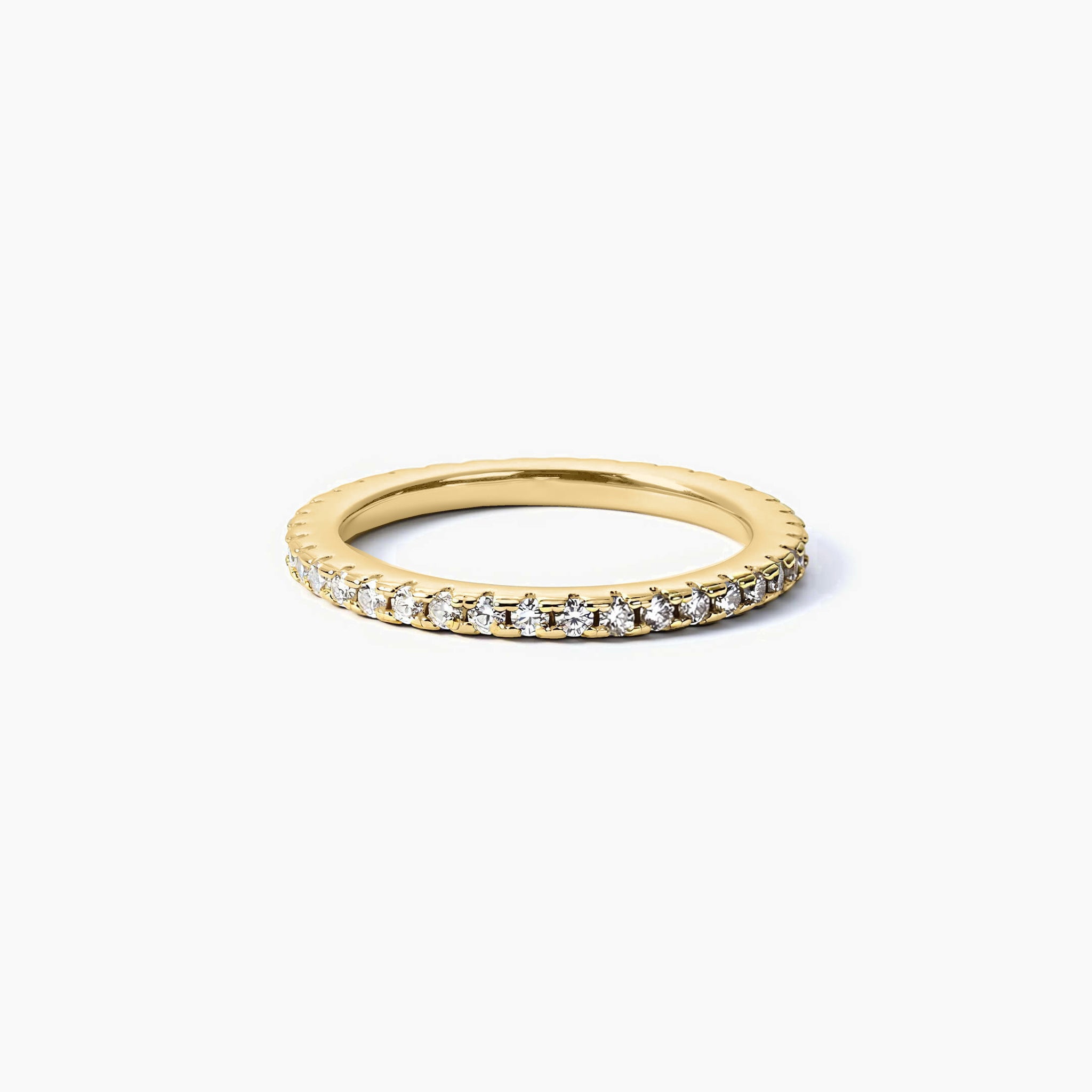 1.5 mm slim moissanite eternity ring in yellow gold vermeil, angled view.