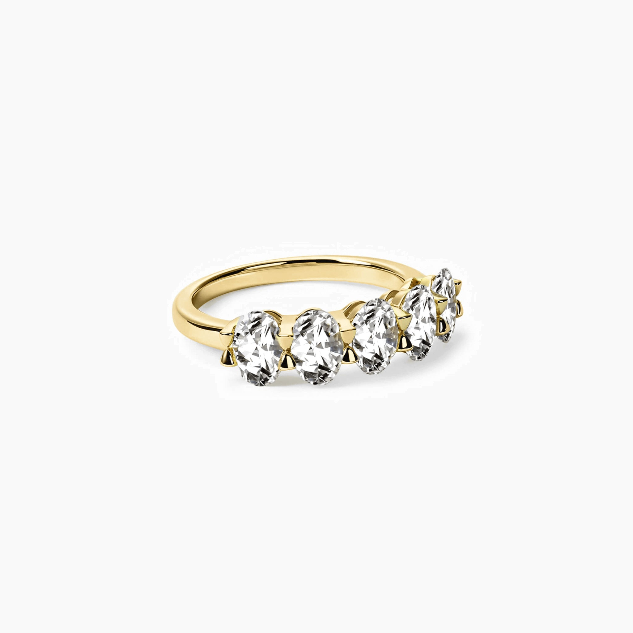 2.5 ct oval-cut moissanite half eternity ring in yellow gold vermeil, angled view.