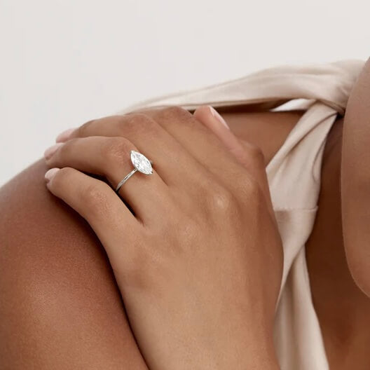 2 ct marquise-cut moissanite solitaire ring worn on a finger.