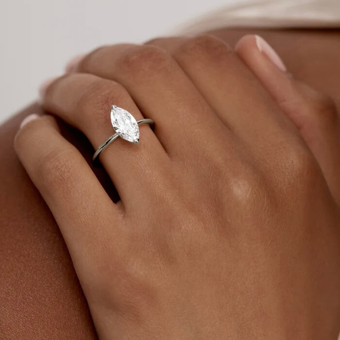 2 ct marquise-cut moissanite solitaire ring worn on a finger.