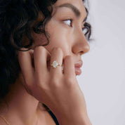 2 ct oval-cut moissanite solitaire ring worn on a finger.