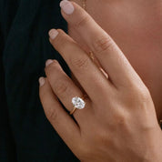 2 ct oval-cut moissanite solitaire ring worn on a finger.