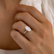 2 ct oval-cut moissanite solitaire ring worn on a finger.