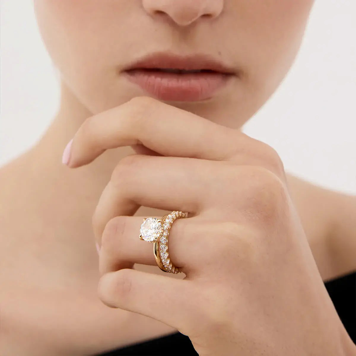 2 ct round-cut moissanite solitaire ring worn on a finger.