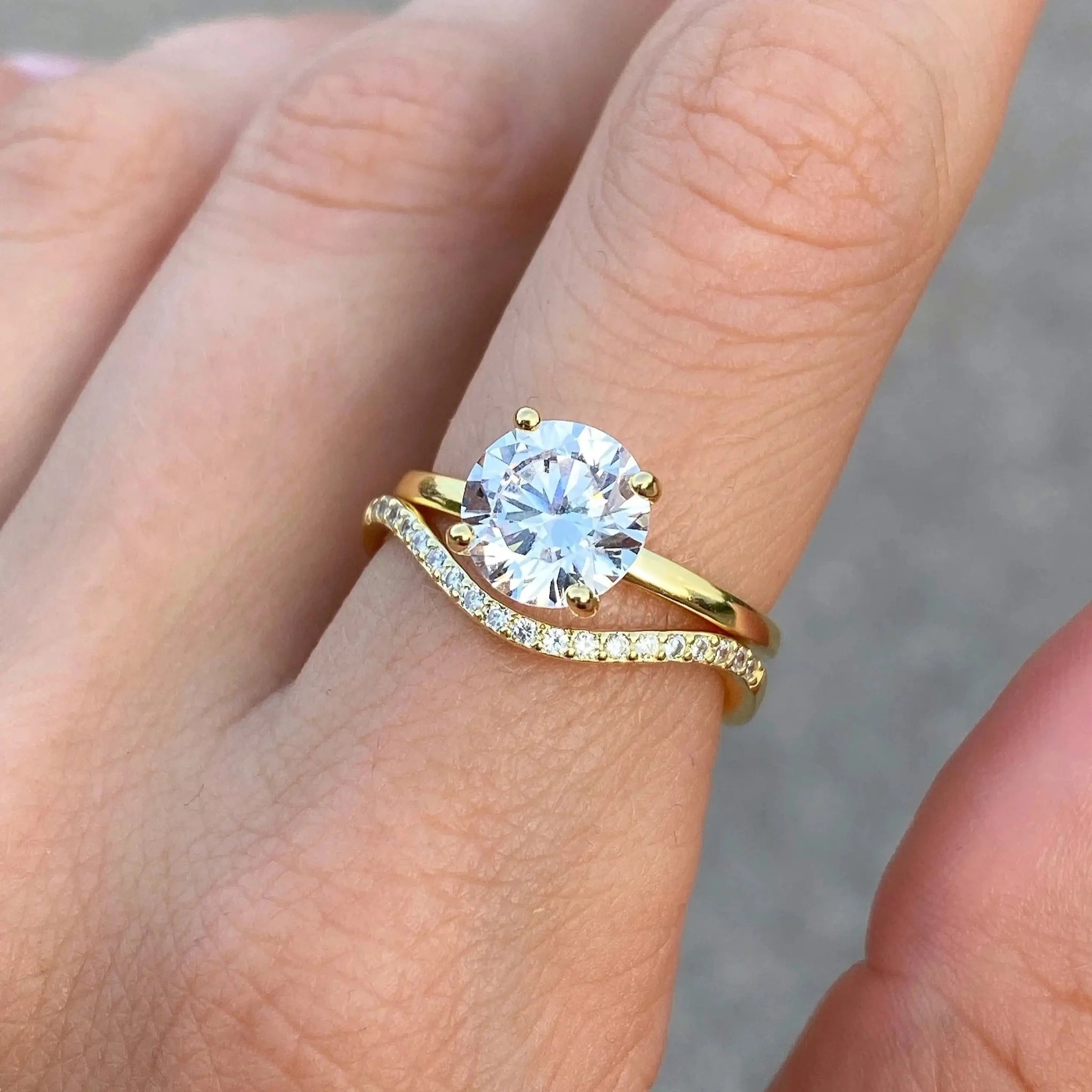 2 ct round-cut moissanite solitaire ring worn on a finger.