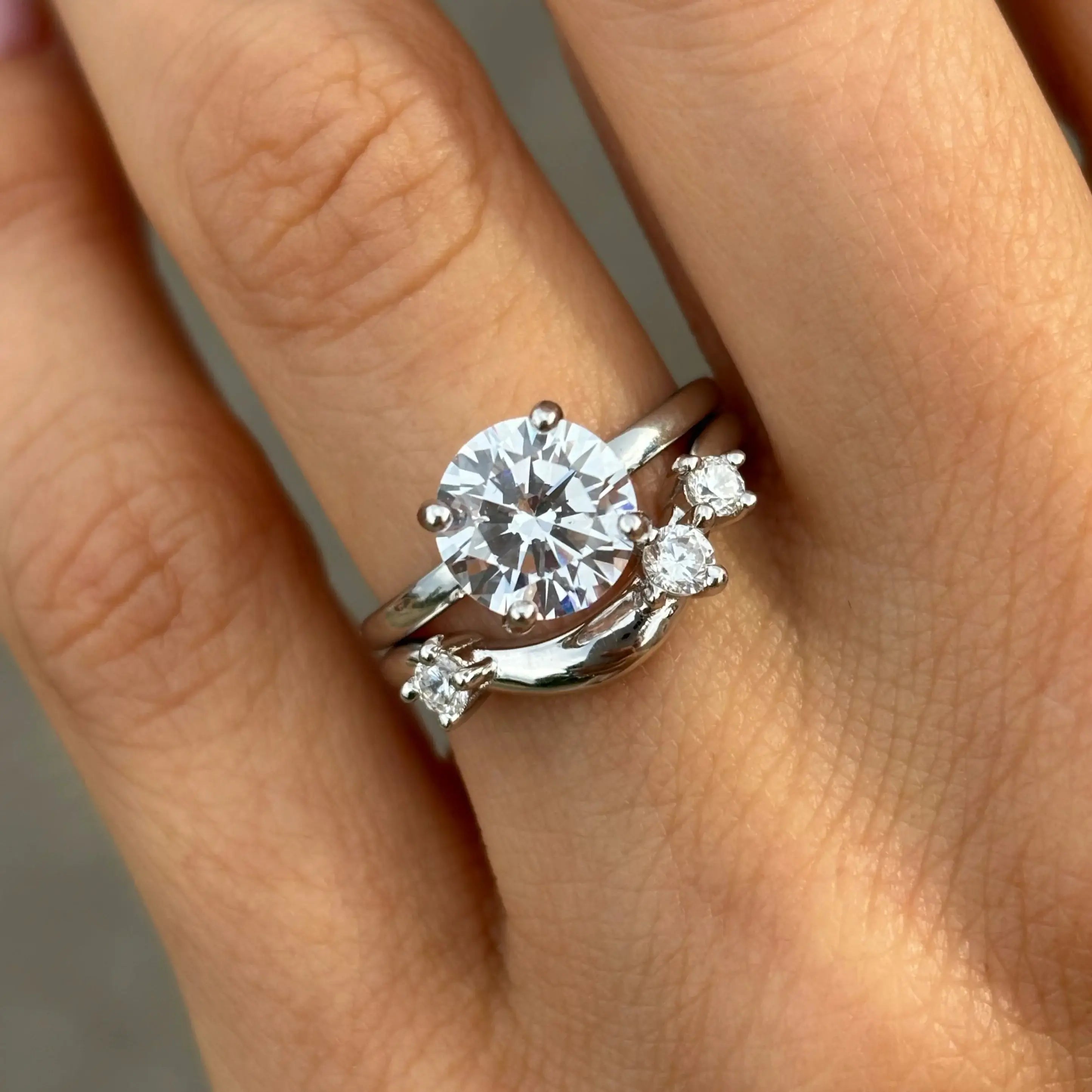 2 ct round-cut moissanite solitaire ring worn on a finger.