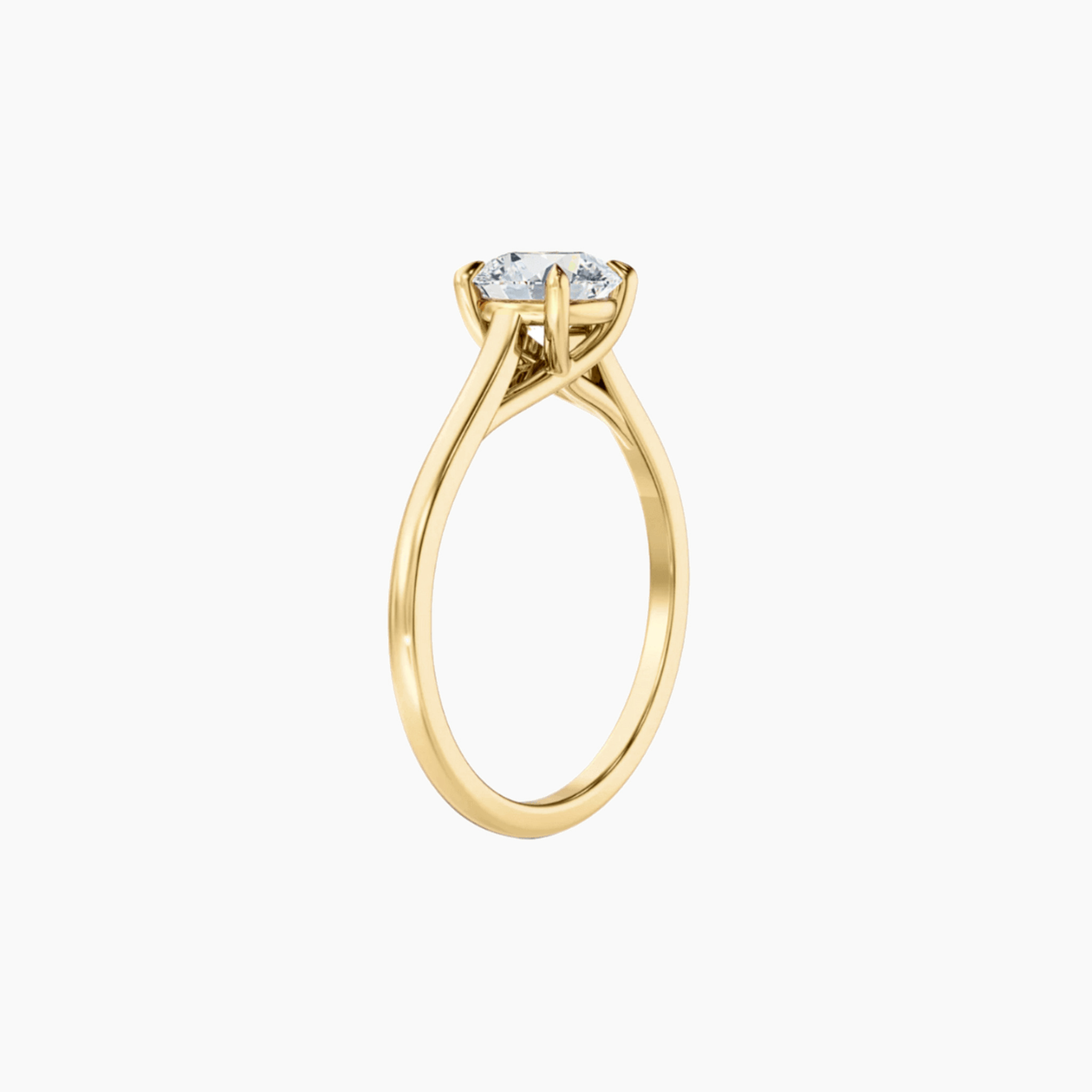 2 ct round-cut moissanite solitaire ring in yellow gold vermeil, side view.