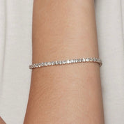 2 mm moissanite tennis bracelet worn on the wrist.
