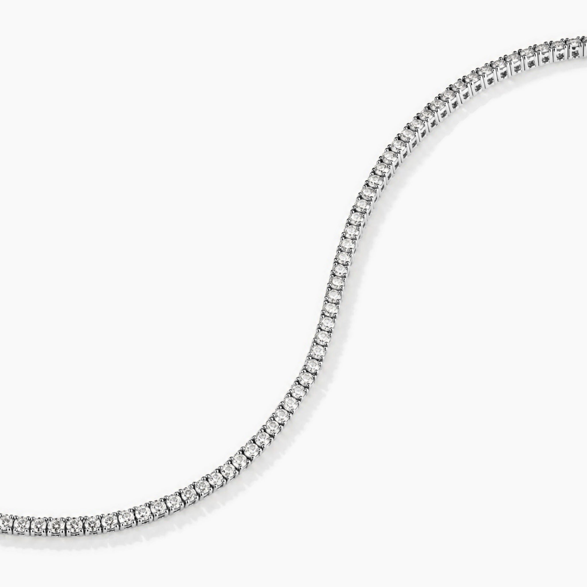 2 mm moissanite tennis bracelet in white gold vermeil, curved stone row detail.