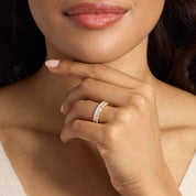 3 ct emerald-cut moissanite half eternity ring worn on a finger.