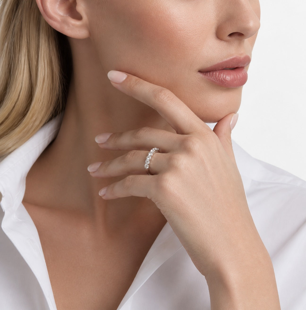3 mm Moissanite Half Eternity Ring worn on a model, hand beside face