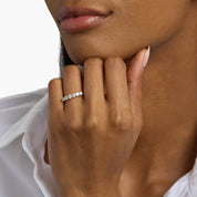 3 mm moissanite half eternity ring worn on a finger.