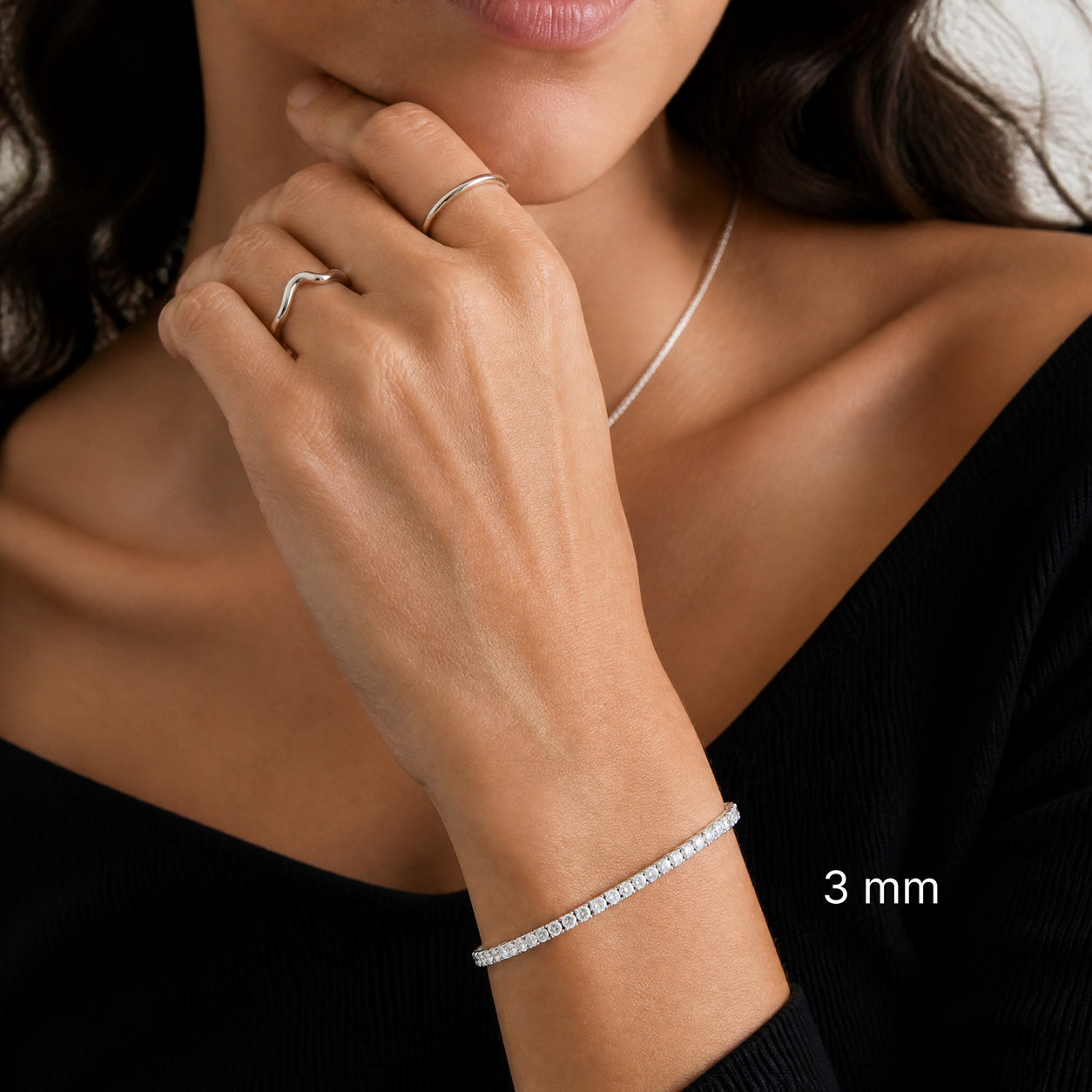 3 mm white gold vermeil moissanite tennis bracelet worn with black outfit, white 3 mm label.