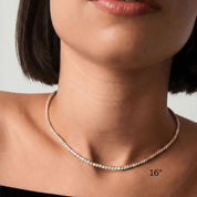 3 mm moissanite tennis necklace worn at the neckline.