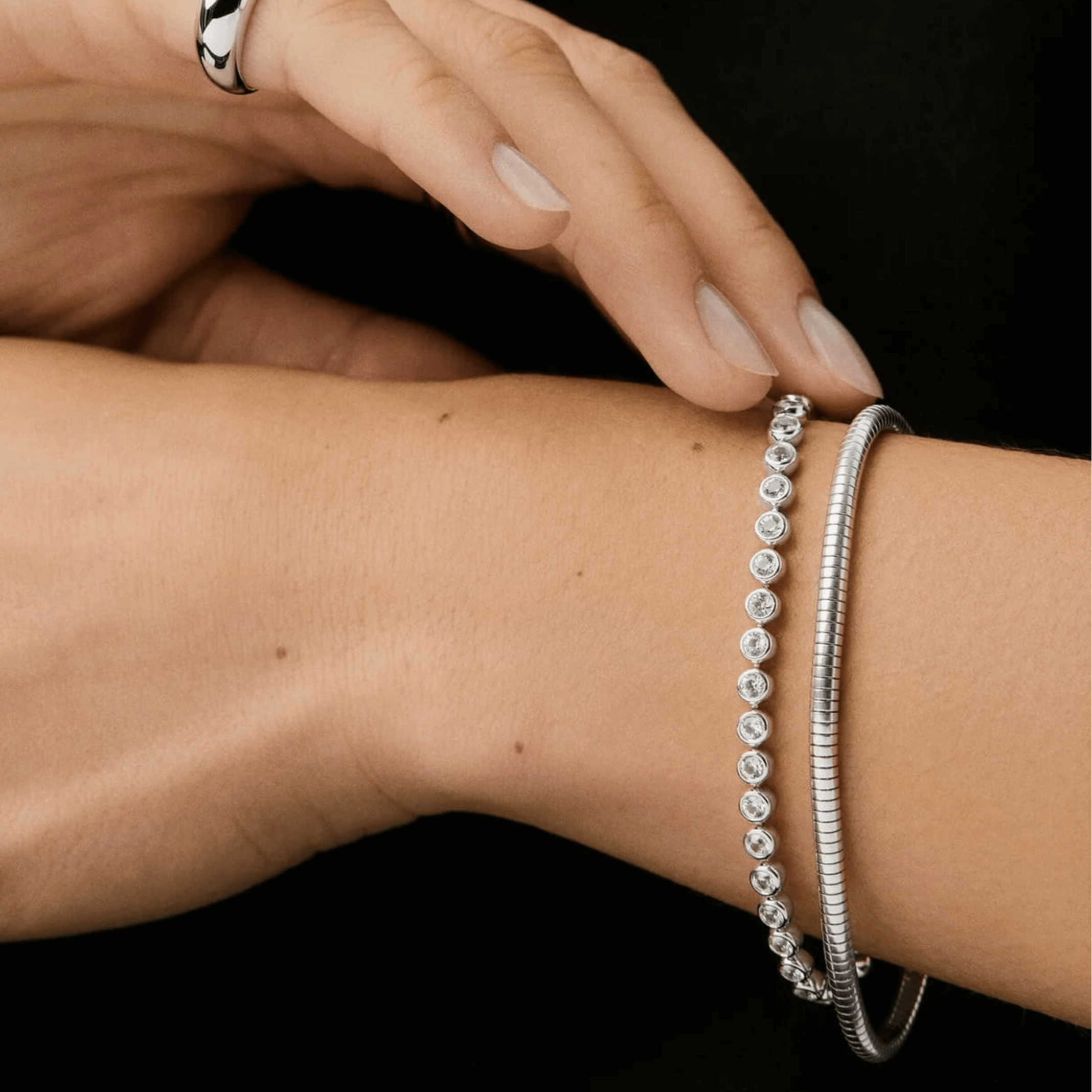 3 mm wide moissanite bezel tennis bracelet worn on the wrist.
