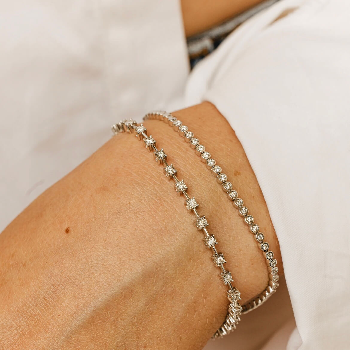 3 mm wide moissanite bezel tennis bracelet worn on the wrist.