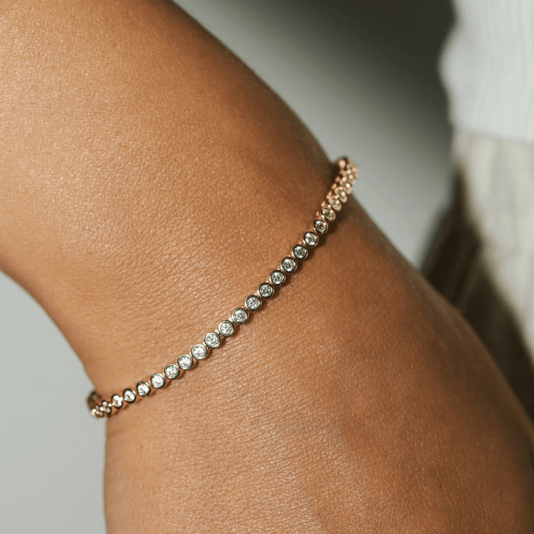 3 mm wide moissanite bezel tennis bracelet worn on the wrist.