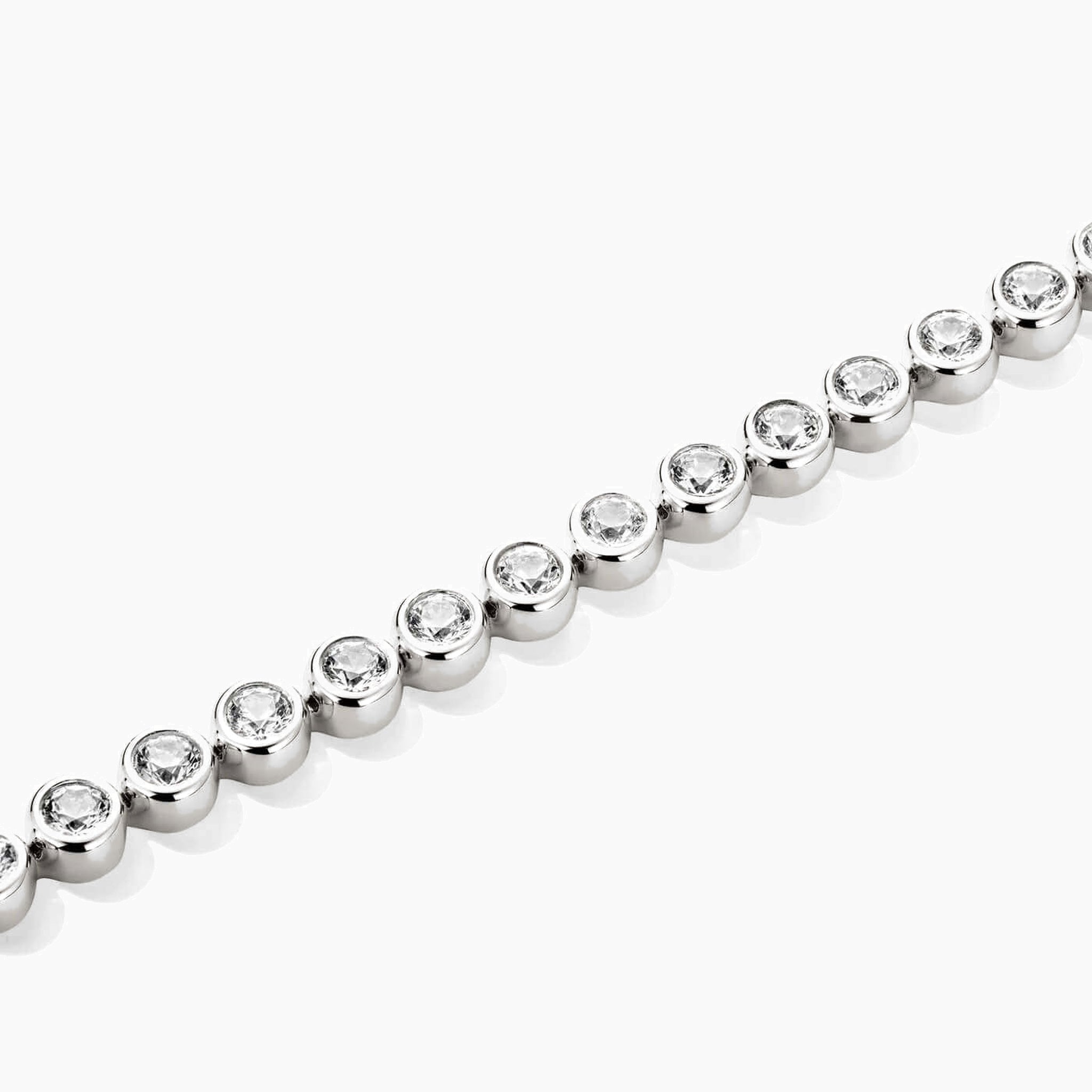 3 mm wide moissanite bezel tennis bracelet in white gold vermeil, close-up detail.