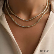 3 mm wide moissanite bezel tennis necklace 16-inch and 18-inch necklaces shown together on the neckline.