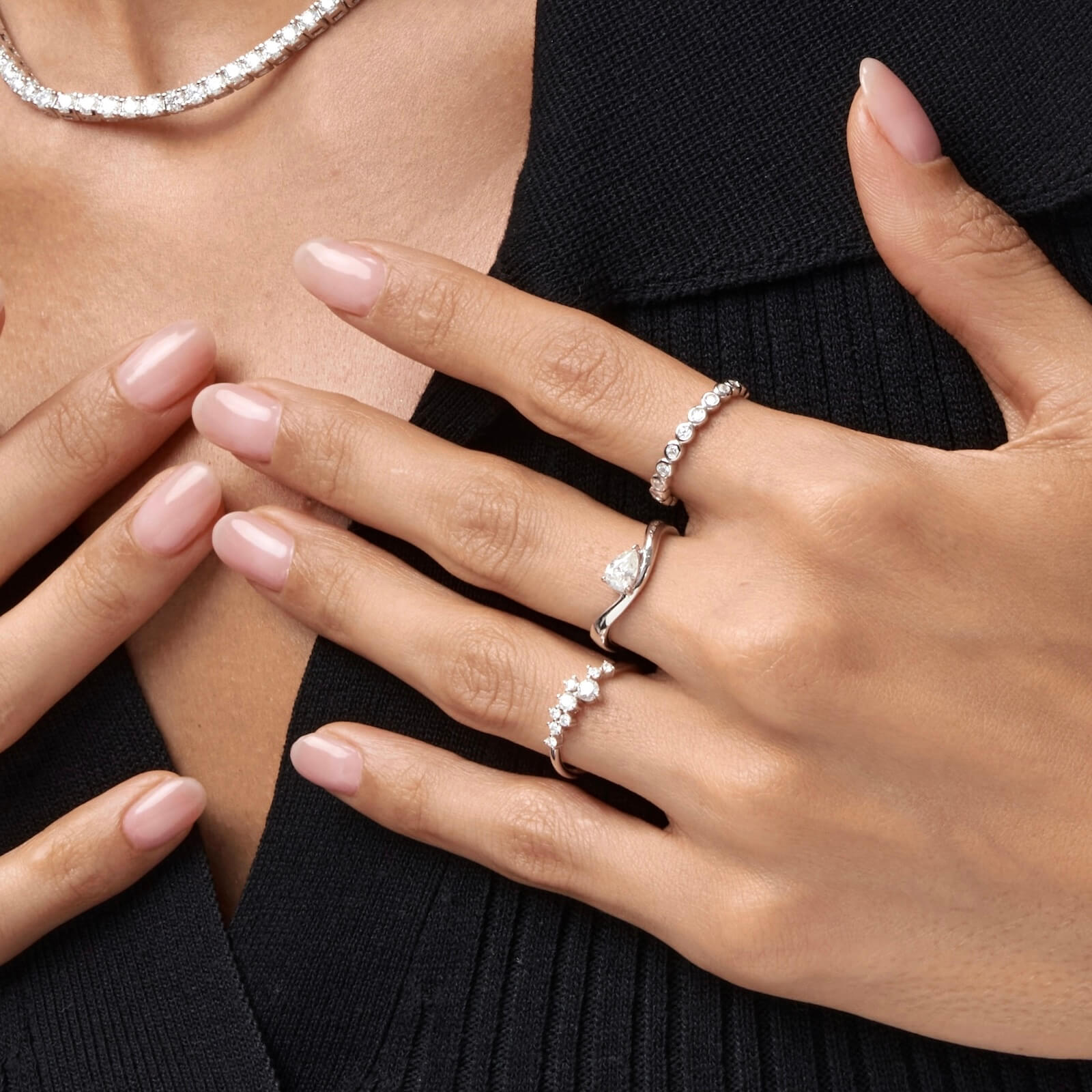 3 mm wide round-cut moissanite bezel eternity ring worn on a finger.