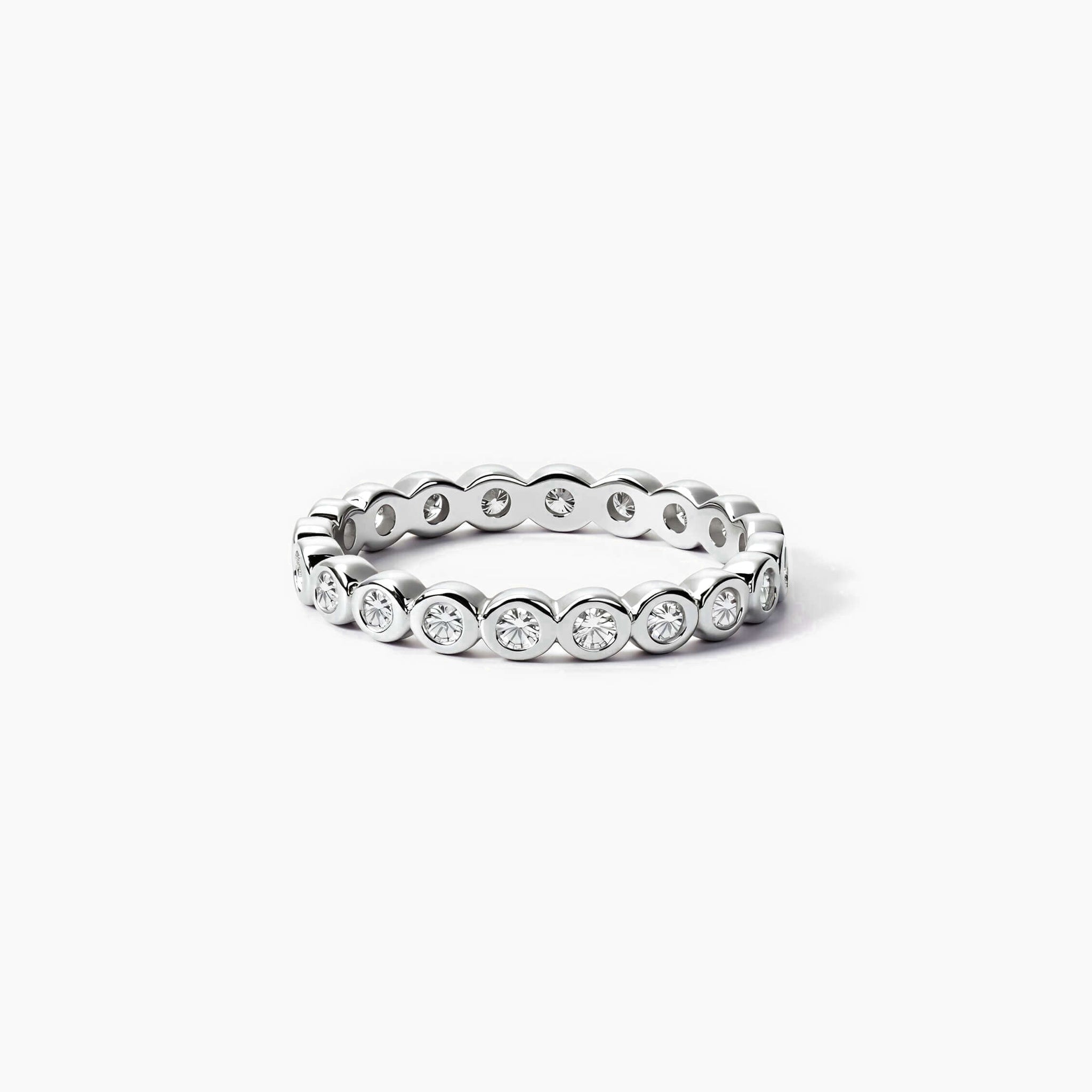 3 mm wide round-cut moissanite bezel eternity ring in white gold vermeil, front view.