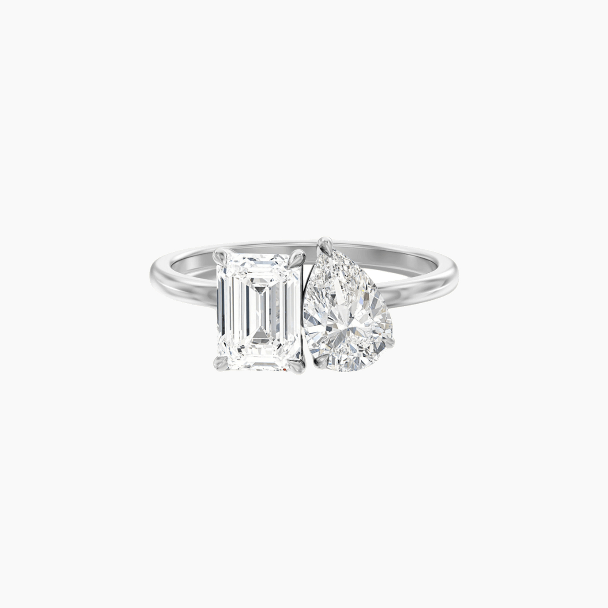 4 ct pear-cut and emerald-cut moissanite toi et moi ring in white gold vermeil, front view.