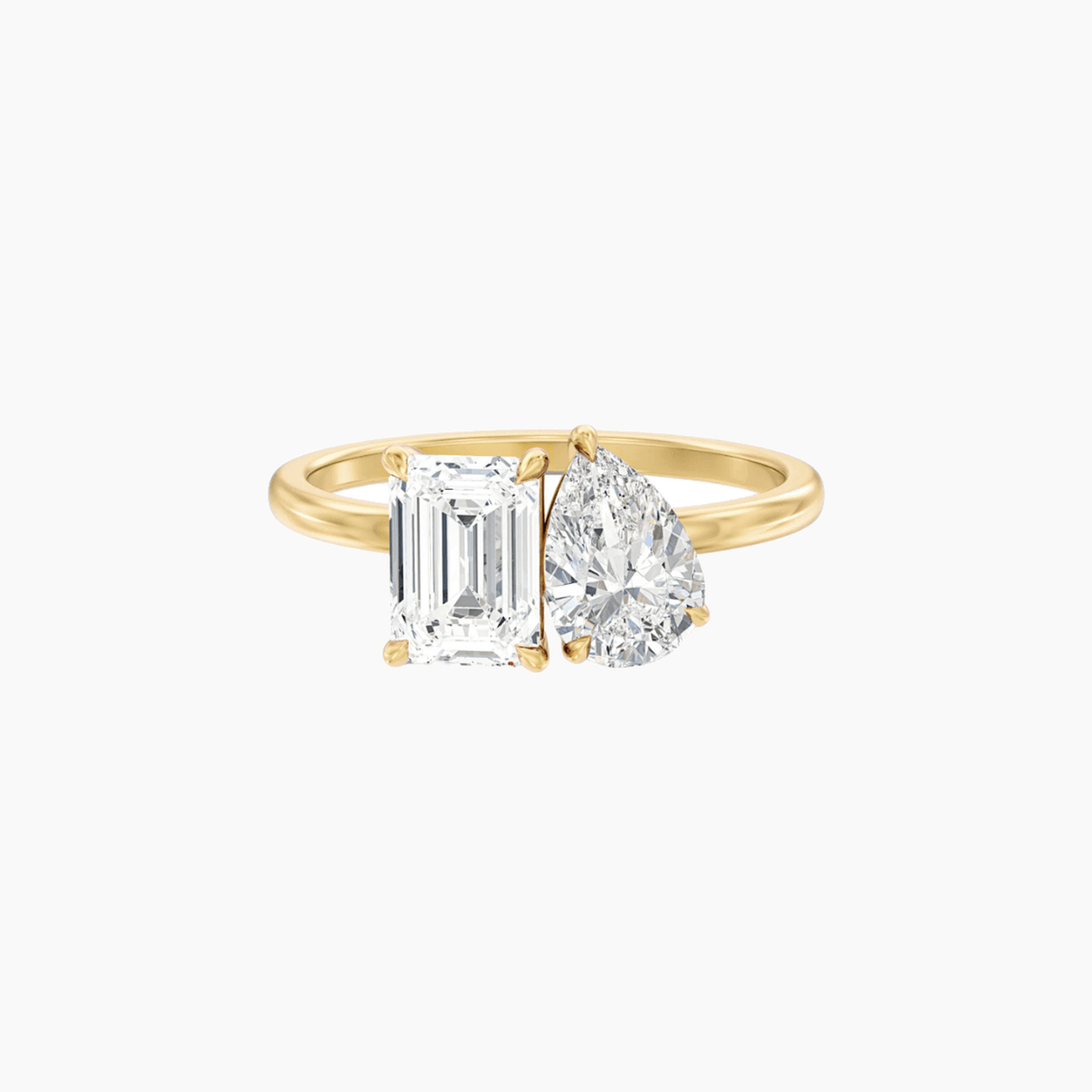 4 ct pear-cut and emerald-cut moissanite toi et moi ring in yellow gold vermeil, front view.