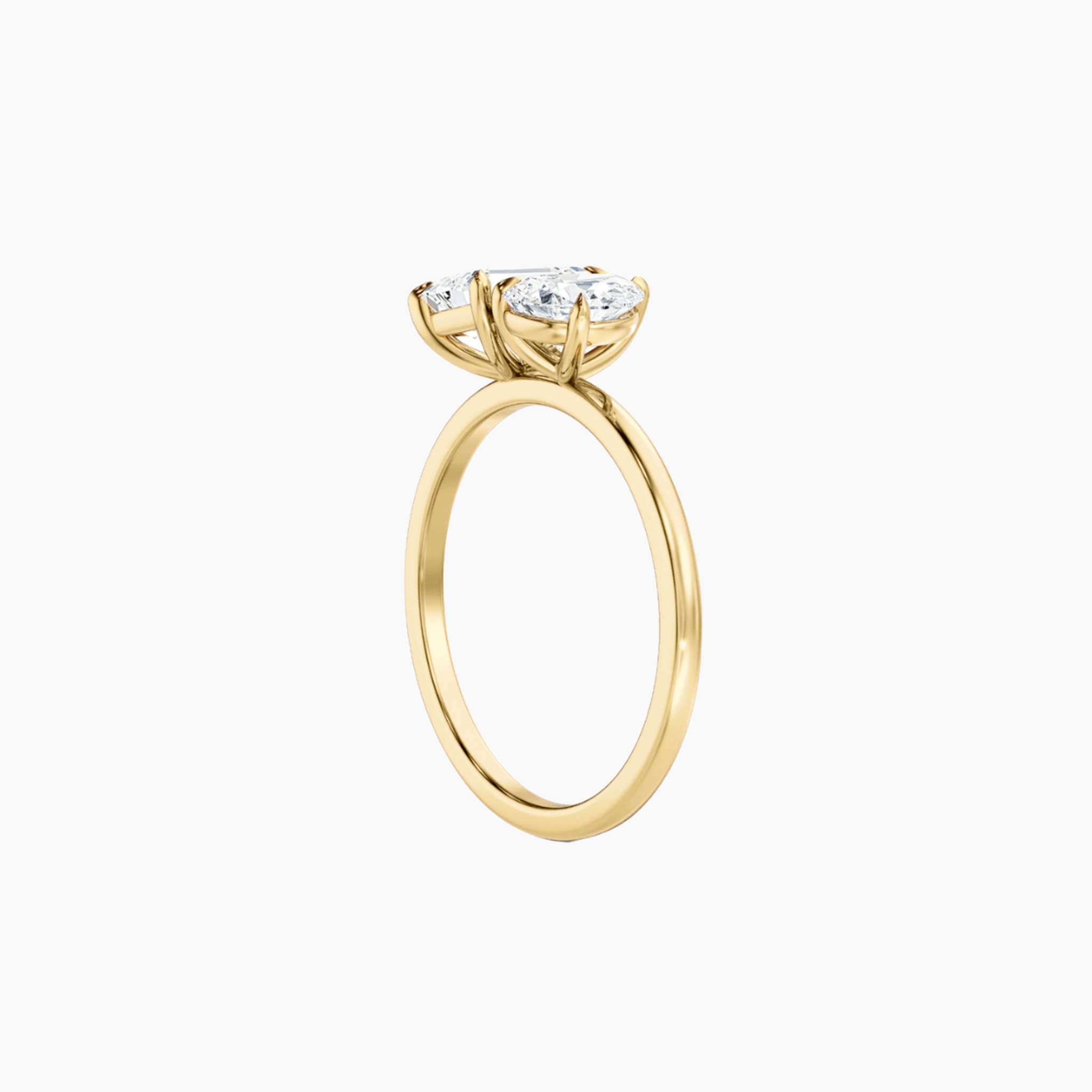 4 ct pear-cut and emerald-cut moissanite toi et moi ring in yellow gold vermeil, side view.