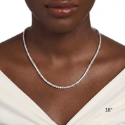 4 mm moissanite tennis necklace worn at the neckline.