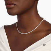 4 mm moissanite tennis necklace worn at the neckline.