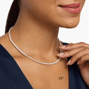 4 mm moissanite tennis necklace worn at the neckline.