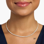 4 mm moissanite tennis necklace worn at the neckline.