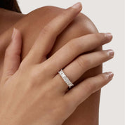 4 mm princess-cut moissanite half eternity ring worn on a finger.