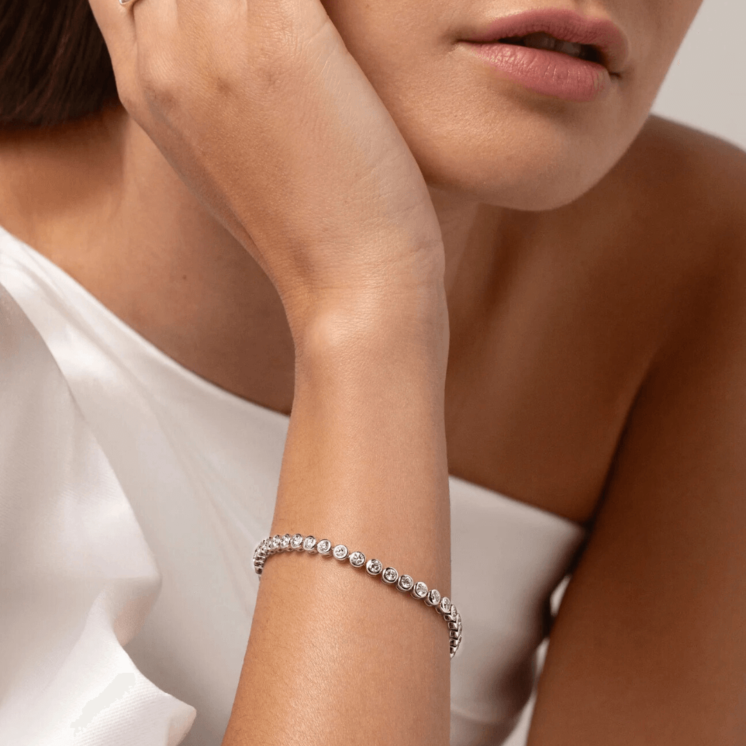 4 mm wide moissanite bezel tennis bracelet worn on the wrist.