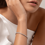 4 mm wide moissanite bezel tennis bracelet worn on the wrist.