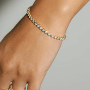 4 mm wide moissanite bezel tennis bracelet worn on the wrist.