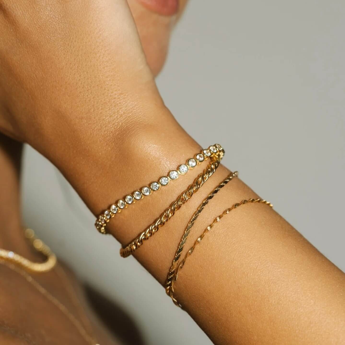 4 mm wide moissanite bezel tennis bracelet worn on the wrist.