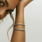 4 mm wide moissanite bezel tennis bracelet worn on the wrist.