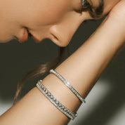 4 mm wide moissanite bezel tennis bracelet worn on the wrist.