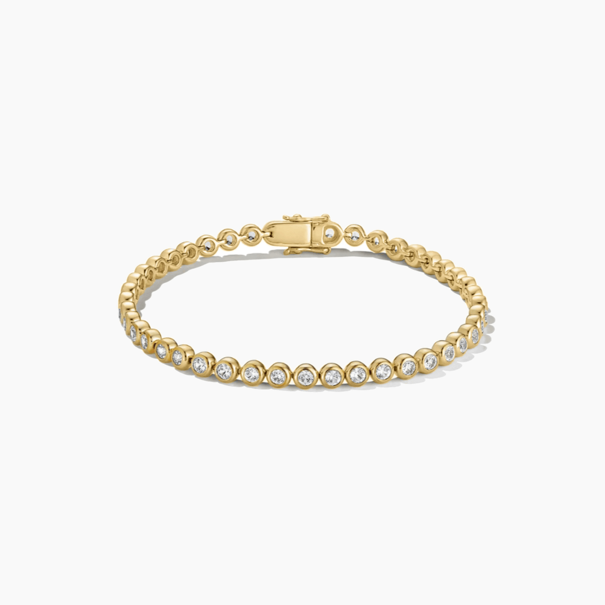 4 mm wide moissanite bezel tennis bracelet in yellow gold vermeil, closed view.