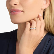 4 mm wide round-cut moissanite bezel eternity ring worn on a finger.