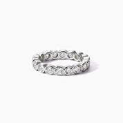 4 mm wide round-cut moissanite bezel eternity ring in white gold vermeil, front view.