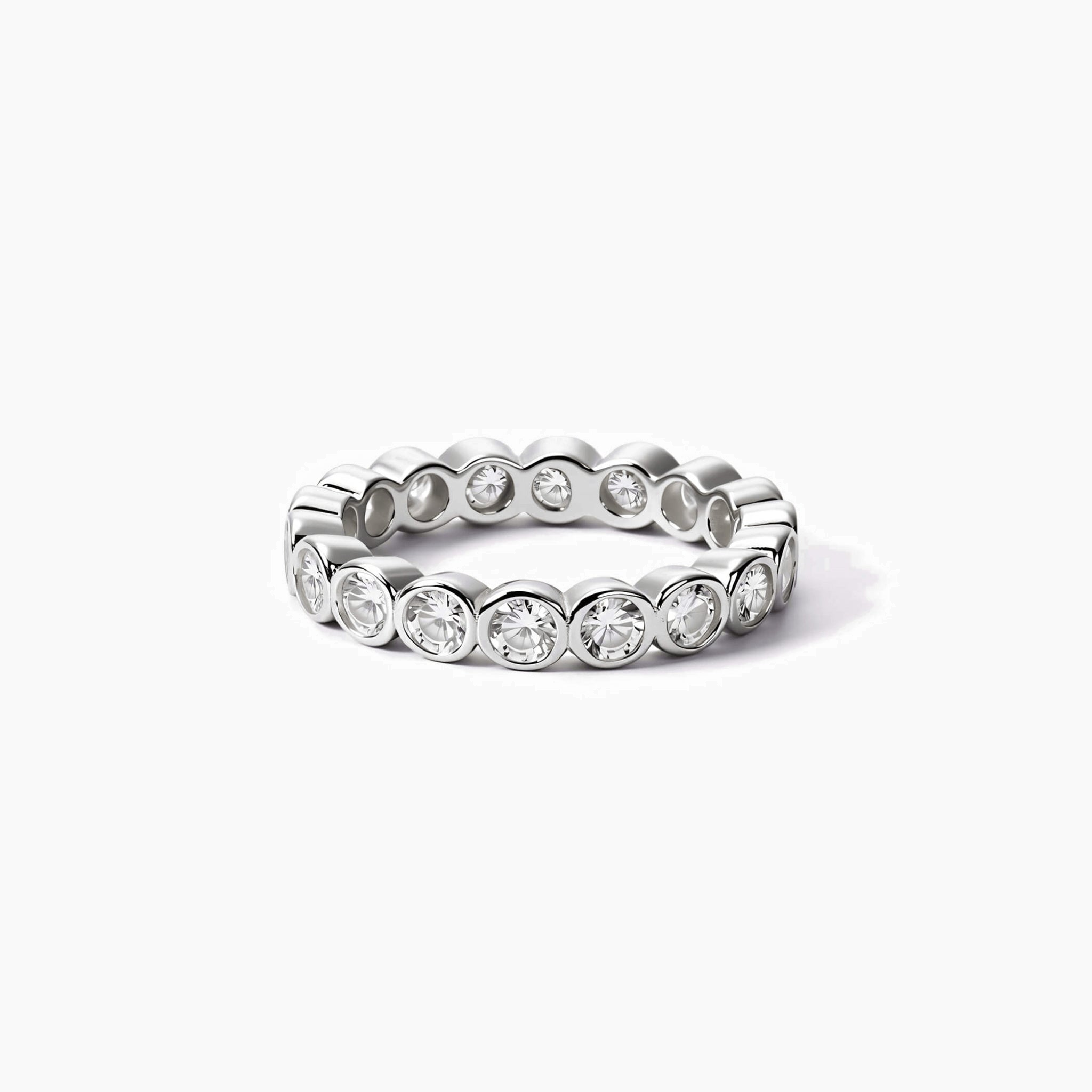 4 mm wide round-cut moissanite bezel eternity ring in white gold vermeil, front view.