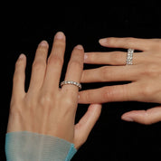 6 mm wide moissanite double-row eternity ring worn on a finger.