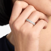 7 ct oval-cut moissanite eternity ring worn on a finger.
