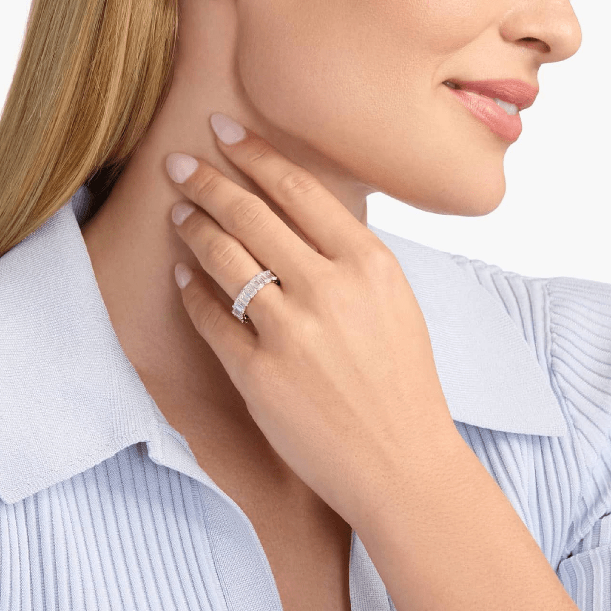9 ct emerald-cut moissanite eternity ring worn on a finger.