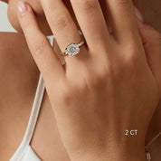 Asscher-cut moissanite bezel solitaire ring worn on a finger with a 2 ct size label.