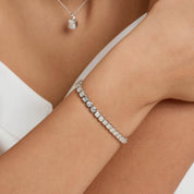 Asscher-cut moissanite bezel tennis bracelet worn on the wrist.