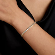Asscher-cut moissanite bezel tennis bracelet worn on the wrist.