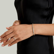 Asscher-cut moissanite bezel tennis bracelet worn on the wrist.